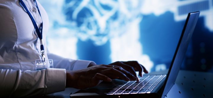 TEch savvy expert writing AI script Admin writing artificial intelligence script code in cloud computing business establishment on laptop terminal. Tech savvy expert doing maintenance work in data center, upgrading AI systems