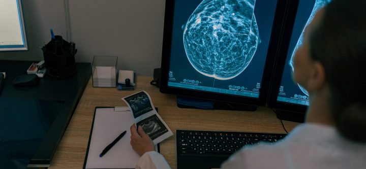 Back view of professional doctor radiologist analyzing scan MRI images in medical center Female doctor neuroscientist analyzing scan MRI images in hospital. High quality photo